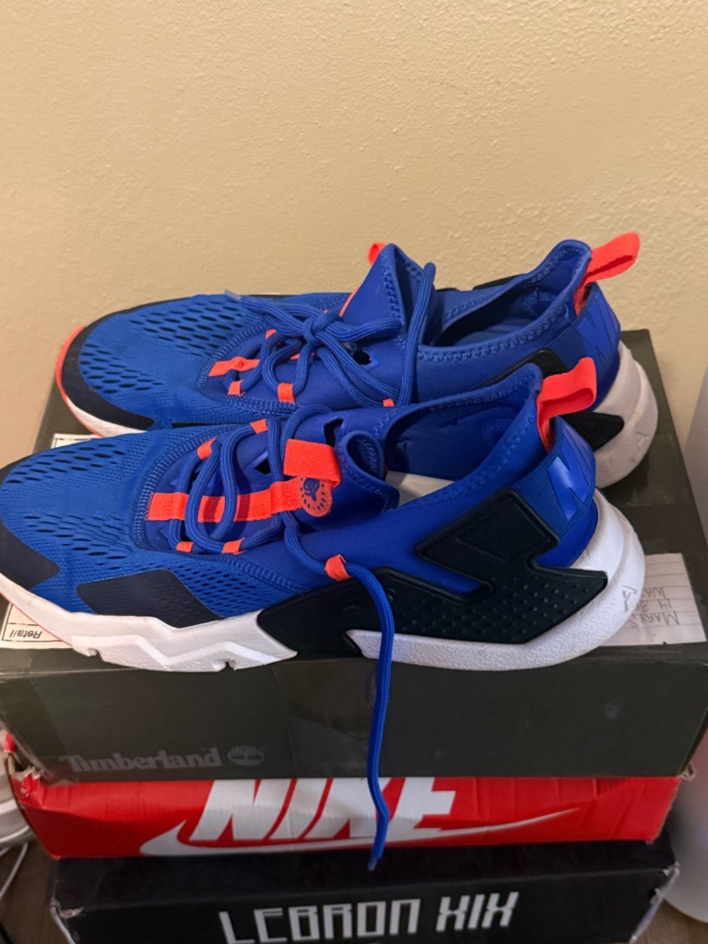 Men’s Air Huarache by Nike Sneakers blue with Neon Orange Accents.